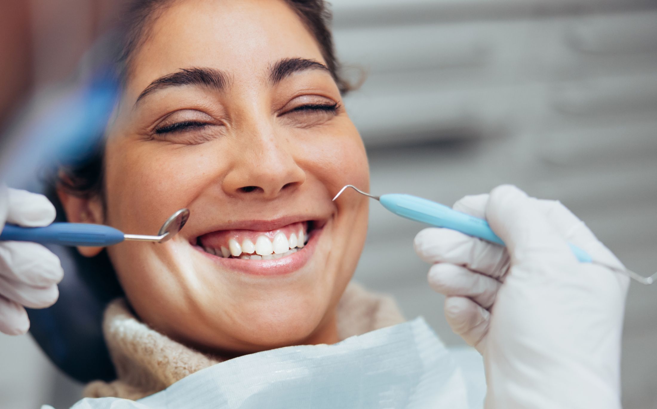 root canal patient model smiling in a dental chair