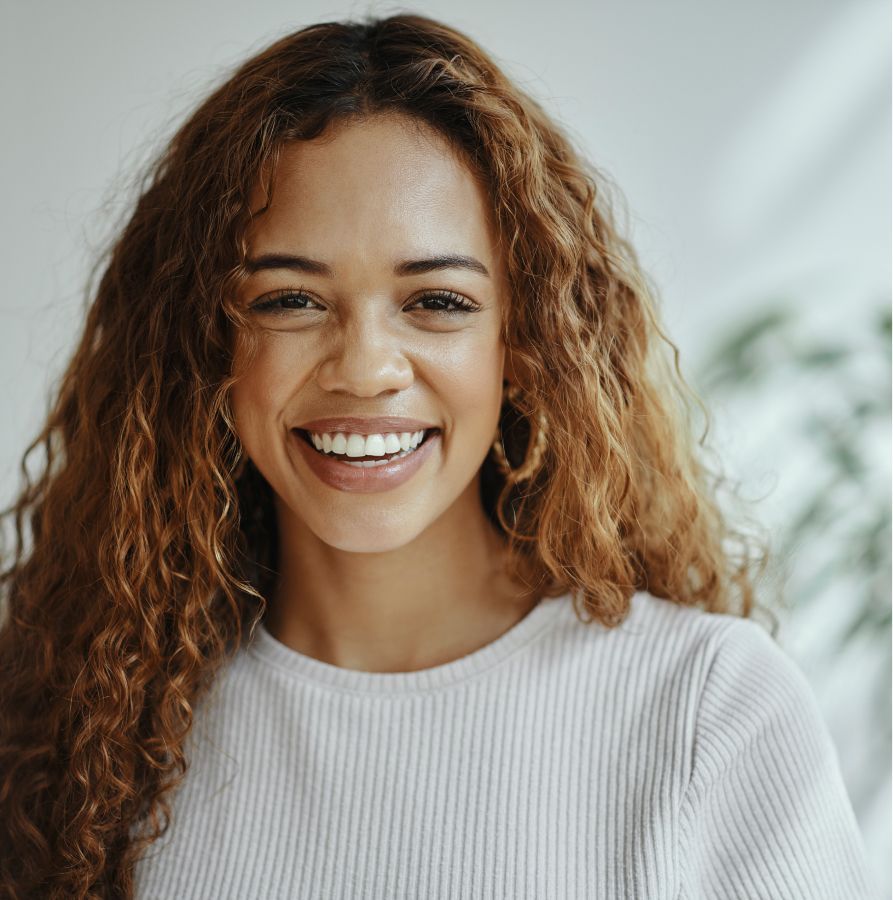 restorative dentistry patient model smiling broadly with large hooped earrings