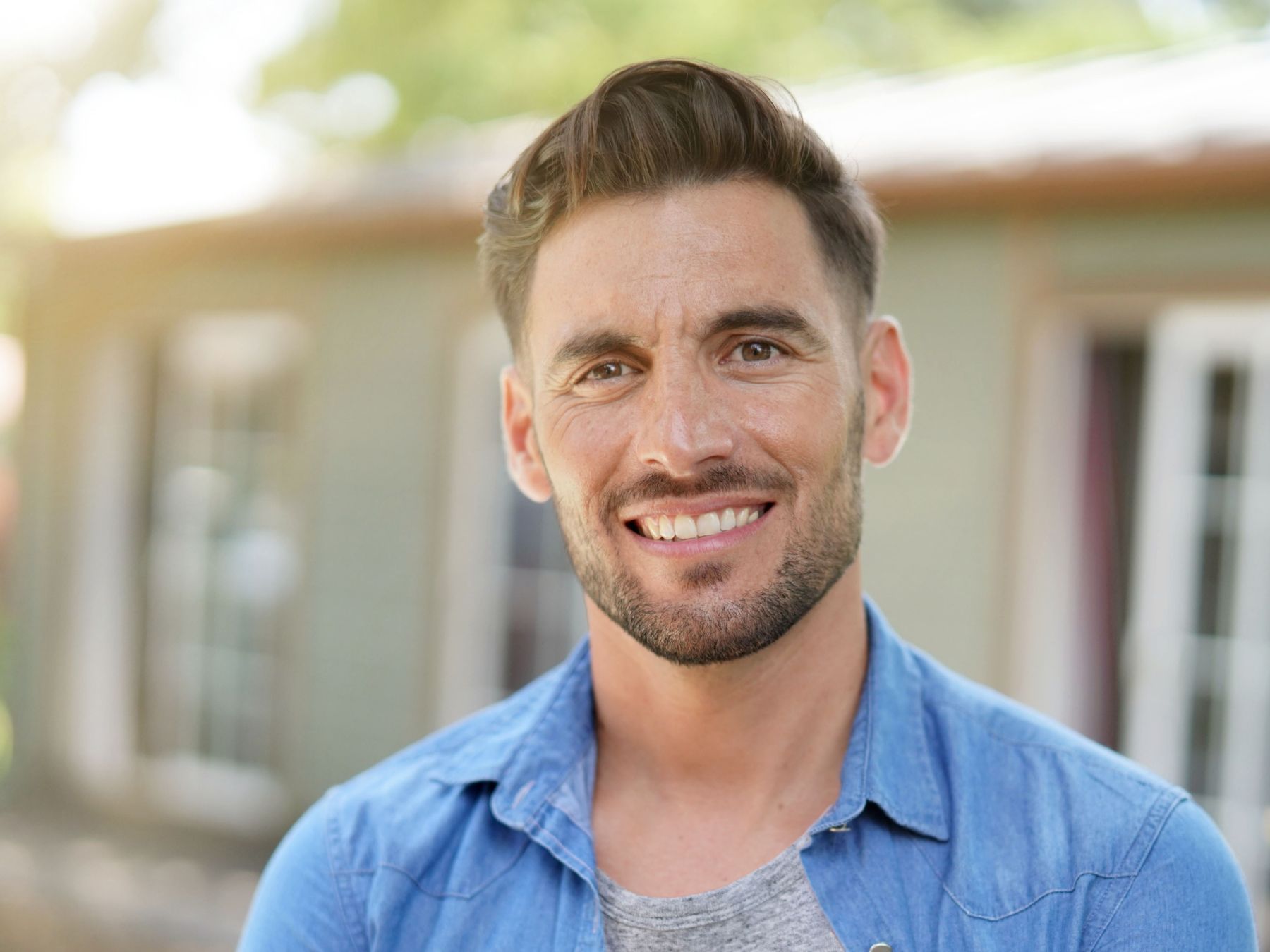 madison dentist patient model smiling in a blue button up shirt