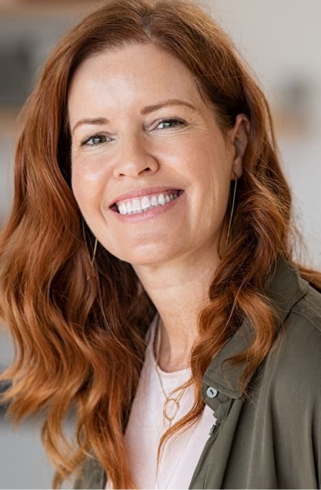  madison dentist patient model smiling with wavy red hair