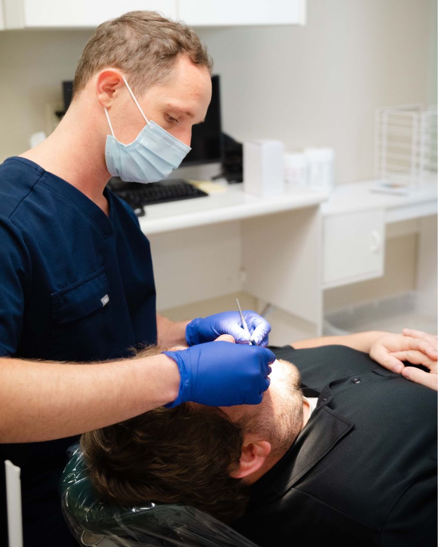 madison dentist dr paul wehner treating a patient model in the operating room