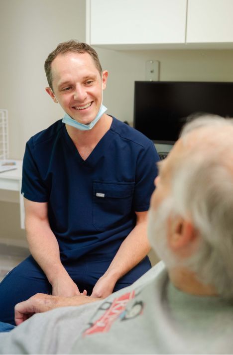 dr paul wehner smiling at a patient model